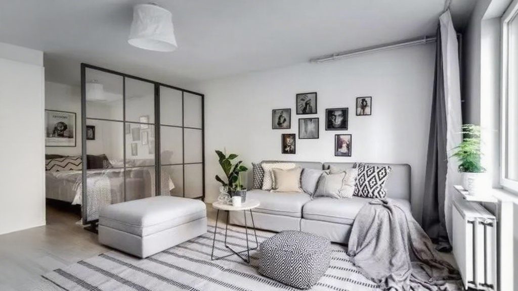 If you have a small home or poor natural light, replacing solid walls with black-framed glass panels instantly creates an airy, spacious feel.